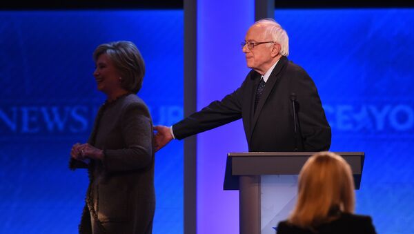 US Democratic presidential hopefuls Hillary Clinton and Bernie Sanders leave the stage during a break in the Democratic Presidential Debate hosted by ABC News at Saint Anselm College in Manchester, New Hampshire, on December 19, 2015 - Sputnik International