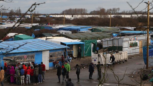 Converted containers, at rear, are placed at the entrance of the Calais refugee camp, northern France - Sputnik International