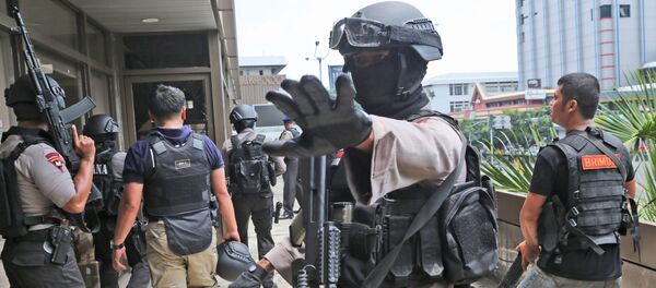 A police officer gestures at reporters as they search buildings near the site of an explosion in Jakarta, Indonesia Thursday, Jan. 14, 2016 A police officer gestures at reporters as they search buildings near the site of an explosion in Jakarta, Indonesia Thursday, Jan. 14, 2016 - Sputnik International
