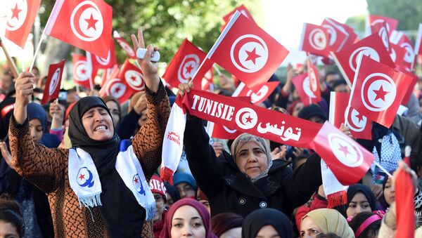 Tunisian women wave national flags and shout slogans on January 14, 2016, during a rally on Habib Bourguiba Avenue in Tunis to mark the fifth anniversary of the 2011 revolution. - Sputnik International