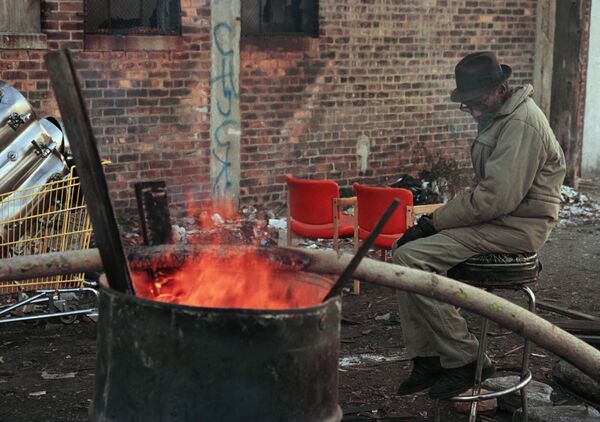 A homeless man sits by a barrel fire to keep warm near downtown Detroit. (File) A homeless man sits by a barrel fire to keep warm near downtown Detroit. (File) - Sputnik International