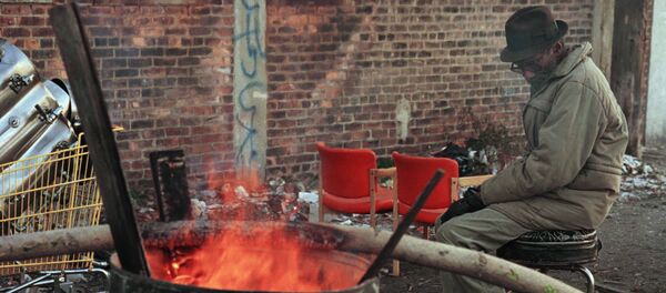 A homeless man sits by a barrel fire to keep warm near downtown Detroit. (File) A homeless man sits by a barrel fire to keep warm near downtown Detroit. (File) - Sputnik International
