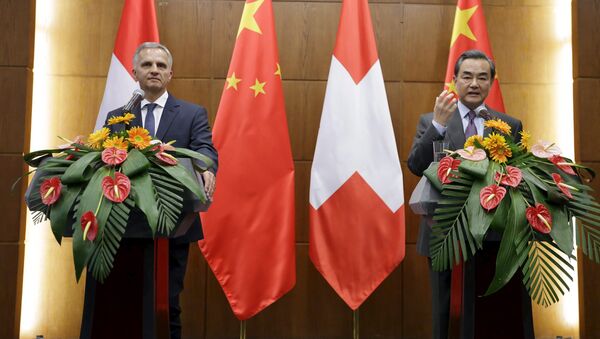 China's Foreign Minister Wang Yi (R) speaks next to Swiss Foreign Minister Didier Burkhalter at a joint news conference after a meeting at the Ministry of Foreign Affairs, in Beijing, China - Sputnik International