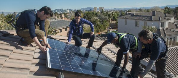 In this handout photograph provided by Sunrun, real estate experts install solar panels on a home in Las Vegas. - Sputnik International