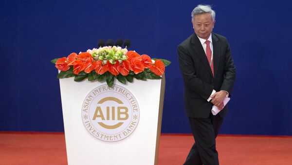 Jin Liqun, the first president of the Asian Infrastructure Investment Bank (AIIB), leaves the podium during the opening ceremony of the AIIB in Beijing Saturday, Jan. 16, 2016 - Sputnik International