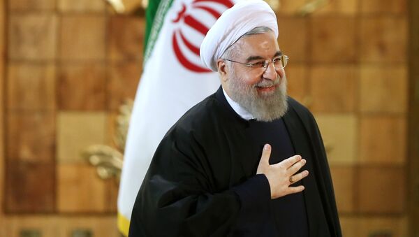Iran's President Hassan Rouhani gestures at the conclusion of his press conference, in Tehran, Iran, Sunday, Jan. 17, 2016. The implementation of a historic nuclear deal with world powers is expected to pave the way for a new economic reality in Iran, now freed from harsh international sanctions - Sputnik International