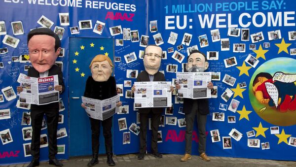 Actors dressed in EU leader face masks pose in front of a refugee message board during a demonstration in front a refugee message board outside of EU headquarters on Monday, Sept. 14, 2015. - Sputnik International