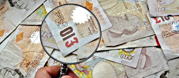 A pile of £10 notes with a magnifying glass A pile of £10 notes with a magnifying glass - Sputnik International