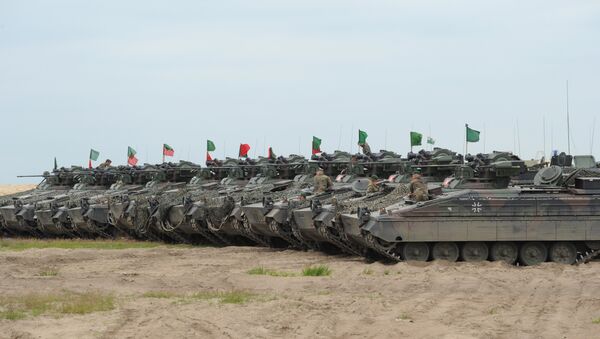 German army tanks line up during the course of the NATO Noble Jump exercise on a training range near Swietoszow Zagan, Poland, June 2015. The German military has seen an increase in deployments for exercises in Eastern Europe and on Russia's borders since the start of the Ukrainian crisis in February 2014. - Sputnik International
