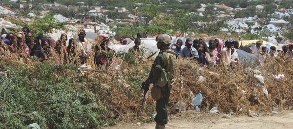 A Somali soldier stands guard during a visit by Turkish Prime Minister Recep Tayyip Erdogan to a refugee camp in Mogadishu, Somalia to witness the famine in Somali capital Friday Aug. 19, 2011 - Sputnik International