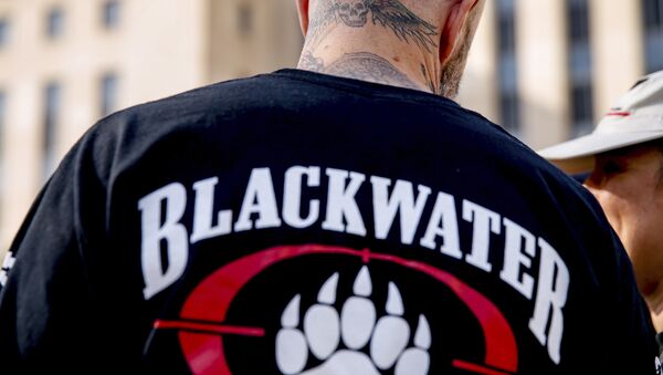 A former member of Blackwater joines family members, friends, and supporters of four former Blackwater security guards outside the federal court in Washington, Monday, April 13, 2015 - Sputnik International