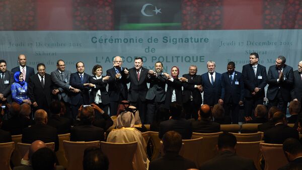 Libyan lawmakers from rival parliaments psoe for a group picture after signing a deal on a unity government on December 17, 2015, in the Moroccan city of Skhirat. - Sputnik International
