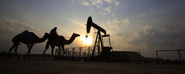 A man rides a camel through the desert oil field and winter camping area of Sakhir, Bahrain, Sunday, Dec. 20, 2015 A man rides a camel through the desert oil field and winter camping area of Sakhir, Bahrain, Sunday, Dec. 20, 2015 - Sputnik International