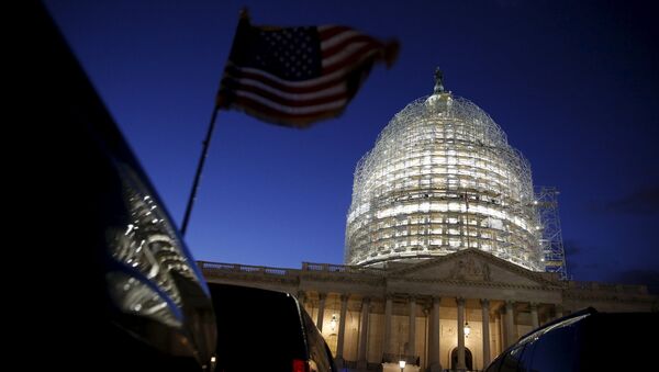 A U.S. flag on a vehicle flutters as the sun sets behind the U.S. Capitol dome in the hours before President Barack Obama delivers the State of the Union address to a joint session of Congress in Washington January 12, 2016 - Sputnik International