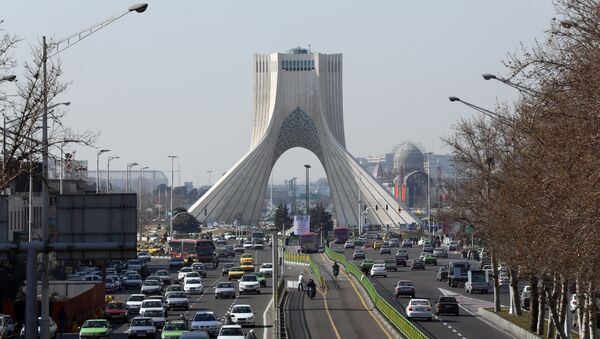 A picture taken on January 18, 2016 shows vehicles driving on a street in front of the Azadi Tower in the capital Tehran - Sputnik International
