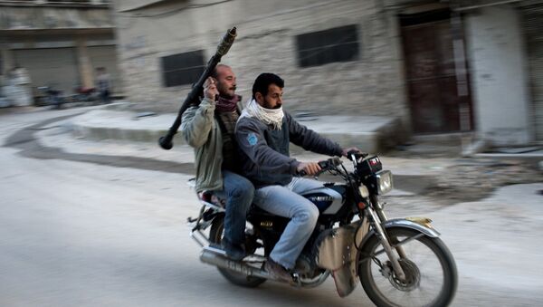 Supporters of the Free Syrian Army ride a motorcycle with a rocket-propelled grenade in Kafar Taharim, Syria. - Sputnik International