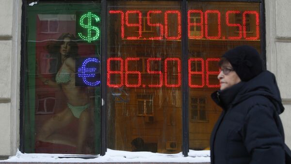 A woman walks past a board showing currency exchange rates of the U.S. dollar and euro against the rouble in Moscow, Russia, January 20, 2016 - Sputnik International