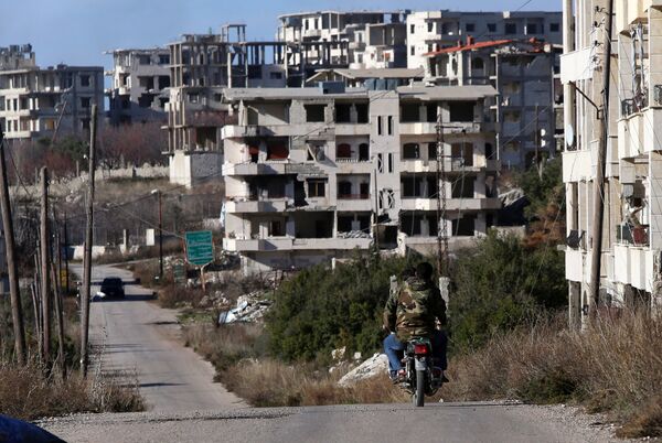 Syrian army soldiers ride a motorcycle in the village of Salma, in the northwestern province of Latakia on January 15, 2016 - Sputnik International