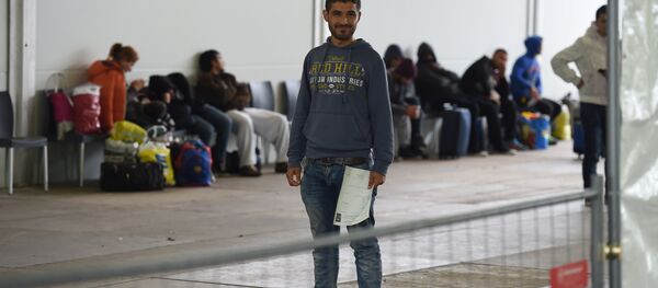 People wait to be registered at the central registration office for refugees in Greven, western Germany, on September 22, 2015 People wait to be registered at the central registration office for refugees in Greven, western Germany, on September 22, 2015 - Sputnik International