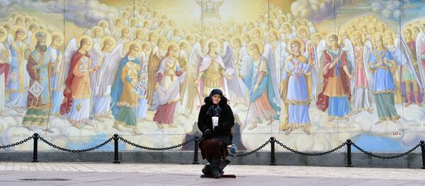 An elderly woman asks for alms outside the Saint Michael Golden-Domed Monastery in Kiev An elderly woman asks for alms outside the Saint Michael Golden-Domed Monastery in Kiev - Sputnik International