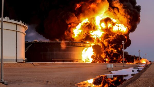 Fire rises from an oil tank in the port of Es Sider, in Ras Lanuf, Libya, in this file picture taken January 4, 2016. - Sputnik International