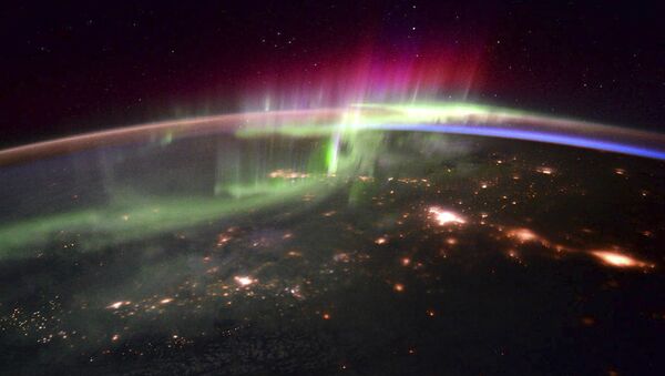 The dancing lights of the Aurora Borealis is shown over the Pacific northwest taken from the International Space Station - Sputnik International