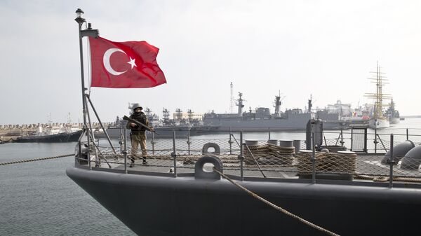 A Turkish marine serviceman stands on the deck of a Turkish navy TCG Turgutreis vessel - Sputnik International
