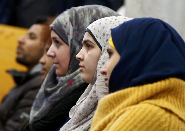 Migrants aged between 16 and 21 years, coming from different countries, attend a lesson on basics in law by Bavarian Justice Minister Winfried Bausback (unseen) at a trade school in Ansbach, Germany, January 11, 2016. Migrants aged between 16 and 21 years, coming from different countries, attend a lesson on basics in law by Bavarian Justice Minister Winfried Bausback (unseen) at a trade school in Ansbach, Germany, January 11, 2016. - Sputnik International