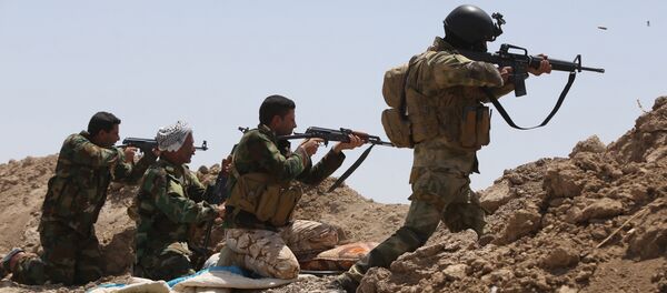 Iraqi soldiers and Shiite fighters from the popular committees hold a post as they fire towards Islamic State (IS) group positions in the Garma district of Anbar province west of the Iraqi capital Baghdad. (File) Iraqi soldiers and Shiite fighters from the popular committees hold a post as they fire towards Islamic State (IS) group positions in the Garma district of Anbar province west of the Iraqi capital Baghdad. (File) - Sputnik International