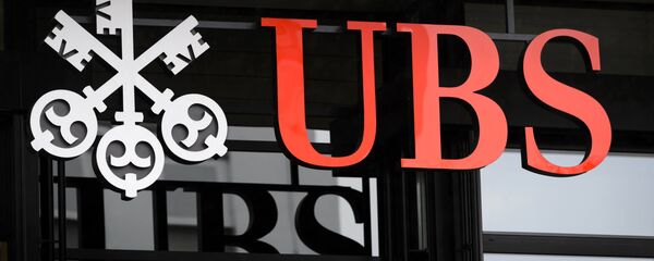 A picture taken on on January 12, 2016 shows the logo of the Swiss global financial services company UBS at the entrance of a branch's building in Zurich. A picture taken on on January 12, 2016 shows the logo of the Swiss global financial services company UBS at the entrance of a branch's building in Zurich. - Sputnik International
