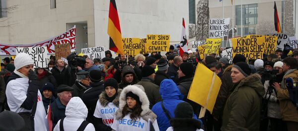 Activists and supporters of the 'International Convention of German Russians' protest against sexual harassment by migrants in front of the Chancellery in Berlin, Germany - Sputnik International
