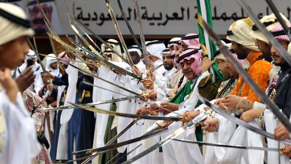 Saudi second deputy Prime Minister Mugren bin Abdulaziz (C-R) and unidentified Emirs perform during the traditional Saudi dancing best known as 'Arda' which performed during the Janadriya culture festival at Der'iya in Riyadh - Sputnik International