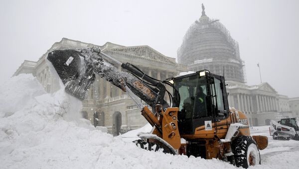 A Capitol Hill employee uses a heavy earth moving machine to clear snow during a winter storm in Washington January 23, 2016. A winter storm dumped nearly 2 feet (58 cm) of snow on the suburbs of Washington, D.C., on Saturday before moving on to Philadelphia and New York, paralyzing road, rail and airline travel along the U.S. East Coas - Sputnik International