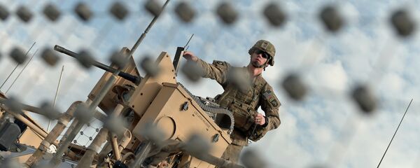 A US soldier of the second Platoon Bravo Company, 1-3271 Infantry of Combined Team Bastogne (Nangarhar), 1st Brigade Combat Team, 101st Airborne Division (Air Assault) loads a machine gun on a manned turret over a mine resistant all-terrain vehicle A US soldier of the second Platoon Bravo Company, 1-3271 Infantry of Combined Team Bastogne (Nangarhar), 1st Brigade Combat Team, 101st Airborne Division (Air Assault) loads a machine gun on a manned turret over a mine resistant all-terrain vehicle - Sputnik International
