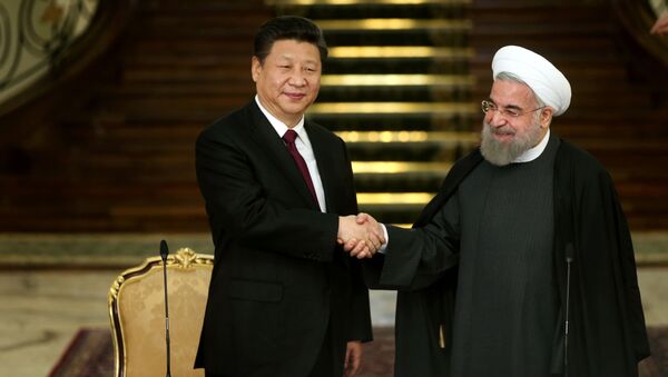 Iranian President Hassan Rouhani, right, and his Chinese counterpart Xi Jinping shake hands at the conclusion of their joint press conference at the Saadabad Palace in Tehran, Iran, Saturday, Jan. 23, 2016 - Sputnik International