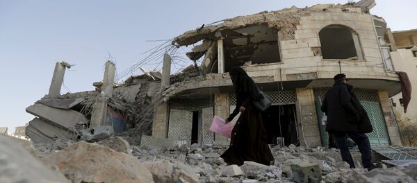 A woman walks past the house of court judge Yahya Rubaid after a Saudi-led air strike destroyed it, killing him, his wife and five other family members, in Yemen's capital Sanaa January 25, 2016 A woman walks past the house of court judge Yahya Rubaid after a Saudi-led air strike destroyed it, killing him, his wife and five other family members, in Yemen's capital Sanaa January 25, 2016 - Sputnik International
