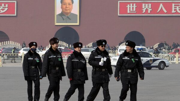 Chinese police officers march across Tiananmen Square outside the Great Hall of the People during a hazy day in Beijing, China, Sunday, March 9, 2014 - Sputnik International