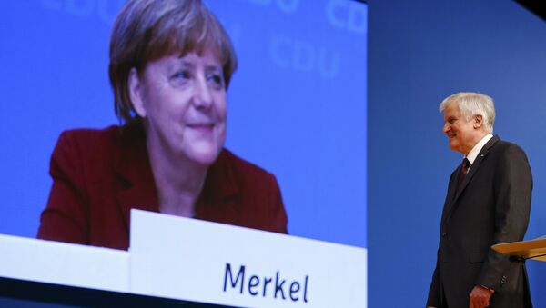 German Chancellor and leader of the Christian Democratic Union (CDU) Angela Merkel is seen on a video screen as Bavarian Prime Minister and head of the Christian Social Union (CSU) Horst Seehofer makes a speech at the CDU party congress in Karlsruhe, Germany in this December 15, 2015. - Sputnik International