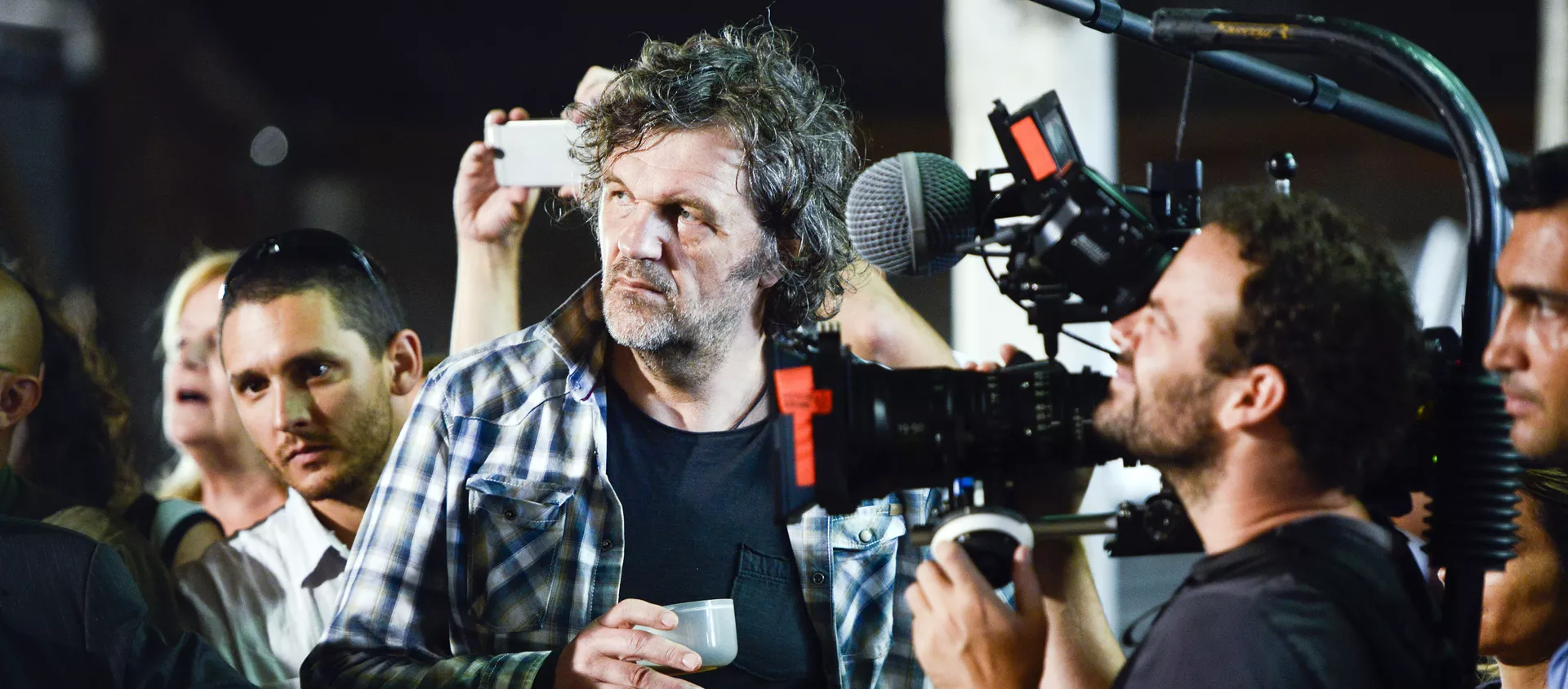 Serbian filmmaker Emir Kusturica, center, stands next to a cameraman while documenting the inauguration of an agricultural trade school that borders the family farm of former President Jose Mujica, on the outskirts of Montevideo, Uruguay, Thursday, March 5, 2015 - Sputnik International, 1920, 16.01.2020