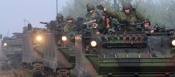 Soldiers ride in tanks during the multinational military exercise for Lithuanian, Polish and Ukrainian troops, Maple Arch 2012, at Pabrade Training Area in Lithuania's Svencionys district, near Vilnius, on September 21, 2012 Soldiers ride in tanks during the multinational military exercise for Lithuanian, Polish and Ukrainian troops, Maple Arch 2012, at Pabrade Training Area in Lithuania's Svencionys district, near Vilnius, on September 21, 2012 - Sputnik International