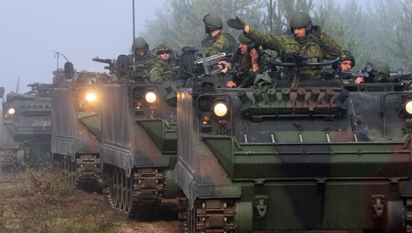 Soldiers ride in tanks during the multinational military exercise for Lithuanian, Polish and Ukrainian troops, Maple Arch 2012, at Pabrade Training Area in Lithuania's Svencionys district, near Vilnius, on September 21, 2012 - Sputnik International