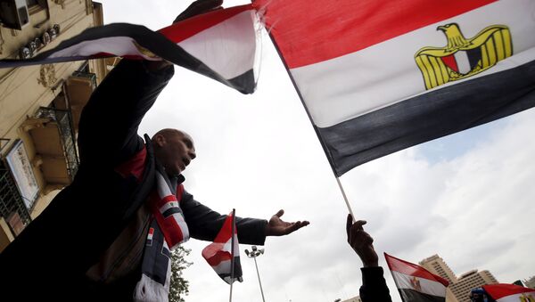 Pro-government protesters chant slogans while holding the national flag during the fifth anniversary of the uprising that ended 30-year reign of Hosni Mubarak in Cairo, Egypt, January 25, 2016 - Sputnik International