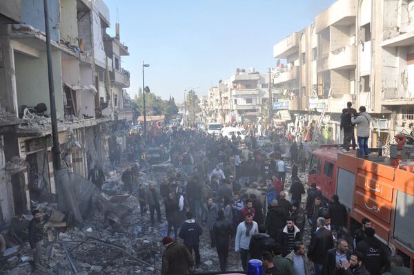 Syrian army soldiers, members of security services and civilians inspect the site of two bomb explosions in the Syrian city of Homs, Syria, in this handout picture provided by SANA on December 28, 2015 Syrian army soldiers, members of security services and civilians inspect the site of two bomb explosions in the Syrian city of Homs, Syria, in this handout picture provided by SANA on December 28, 2015 - Sputnik International
