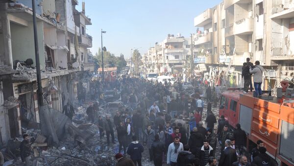Syrian army soldiers, members of security services and civilians inspect the site of two bomb explosions in the Syrian city of Homs, Syria, in this handout picture provided by SANA on December 28, 2015 - Sputnik International