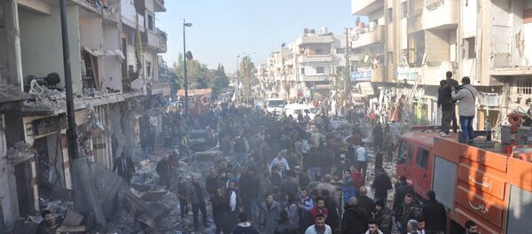 Syrian army soldiers, members of security services and civilians inspect the site of two bomb explosions in the Syrian city of Homs, Syria, in this handout picture provided by SANA on December 28, 2015 Syrian army soldiers, members of security services and civilians inspect the site of two bomb explosions in the Syrian city of Homs, Syria, in this handout picture provided by SANA on December 28, 2015 - Sputnik International