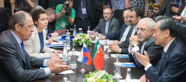Minister of Foreign Affairs of the Russian Federation Sergei Lavrov, left, Minister of Foreign Affairs of the People's Republic of China Wang Yi, right, and Minister of Foreign Affairs of the Islamic Republic of Iran Mohammad Javad Zarif, second right, during a trilateral meeting as part of the High-Level Conference on Security and Stability in the SCO Region - Sputnik International