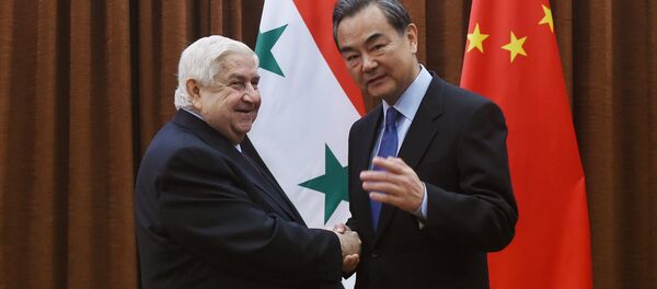 Syrian Foreign Minister Walid Muallem (L) is welcomed by Chinese Foreign Minister Wang Yi before a meeting in Beijing on December 24, 2015 Syrian Foreign Minister Walid Muallem (L) is welcomed by Chinese Foreign Minister Wang Yi before a meeting in Beijing on December 24, 2015 - Sputnik International