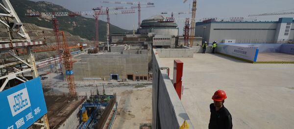 Workers wait for French Prime Minister Jean-Marc Ayrault to arrive at the joint Sino-French Taishan Nuclear Power Station outside Taishan City in Guandong province on December 8, 2013 - Sputnik International