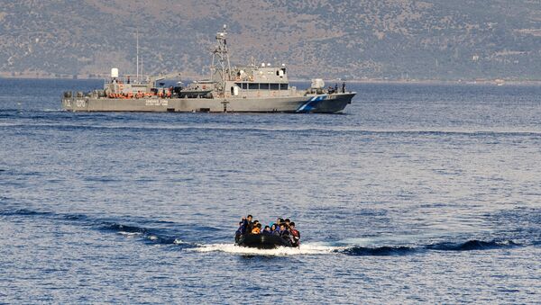 A Greek coast guard ship is seen behind a rubber boat with refugees and migrants near the Greek island of Lesbos after crossing the Aegean Sea from Turkey on October 13, 2015 - Sputnik International