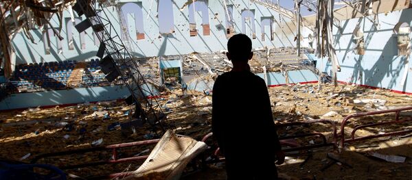 A Yemeni boy inspect the damage at a sports hall that was partially destroyed by Saudi-led air strikes in the Yemeni capital Sanaa on January 19, 2016. - Sputnik International